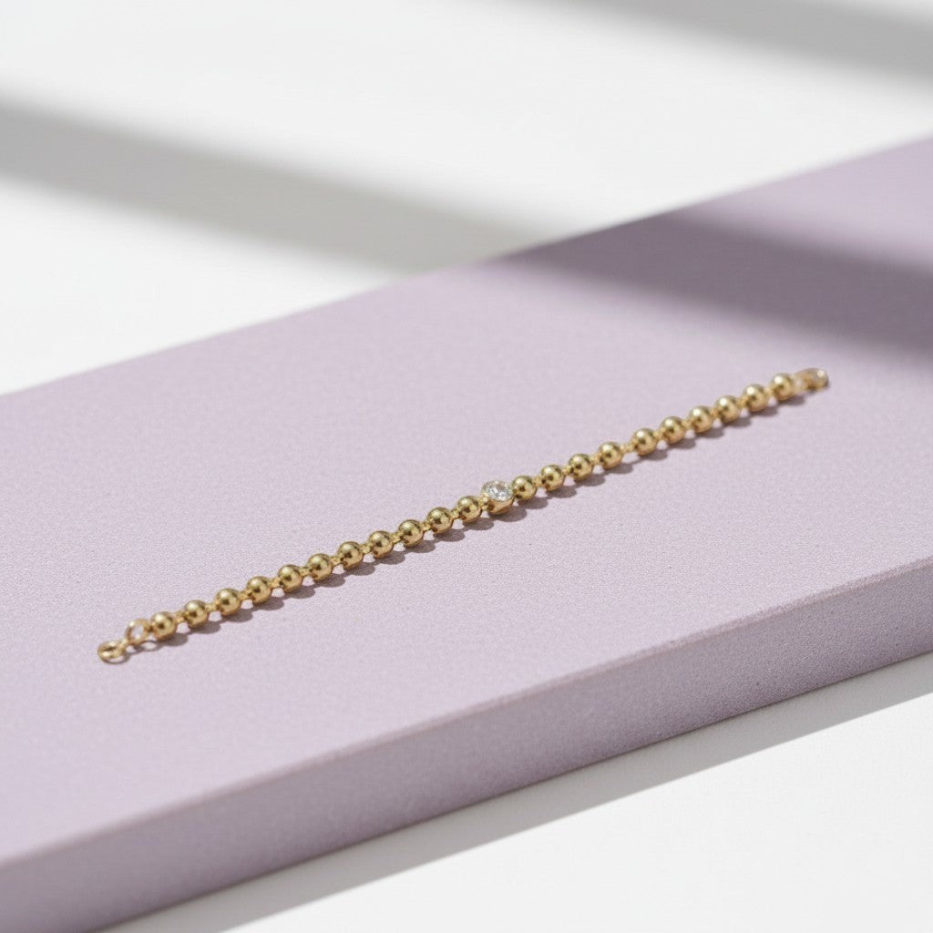 Perlizia gold-plated S925 sterling silver beaded bracelet with a 1ct Moissanite center stone.