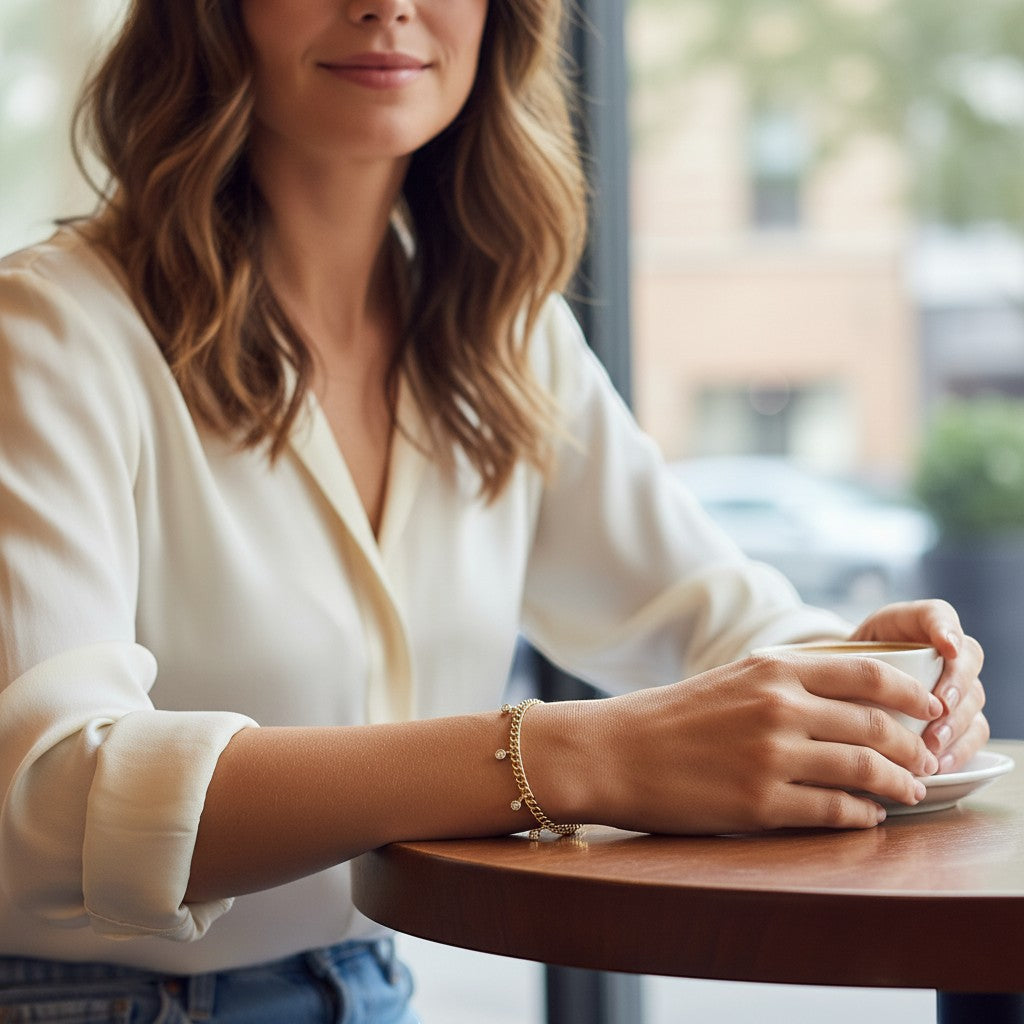Perlizia gold-plated S925 sterling silver Cuban link bracelet with five bezel-set moissanite charms.