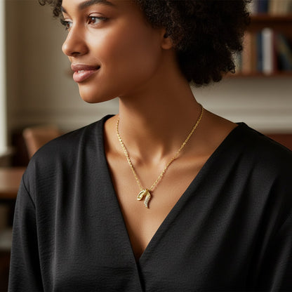 Perlizia gold plated S925 sterling silver ribbon knot pendant necklace with moissanite accents.