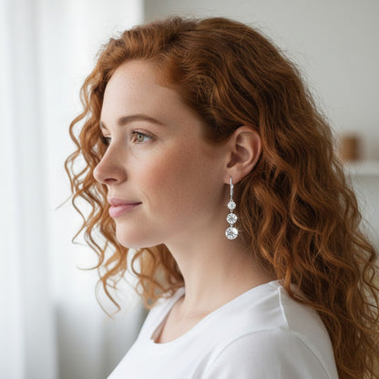 Perlizia platinum-plated S925 sterling silver drop earrings with three graduated moissanite stones.