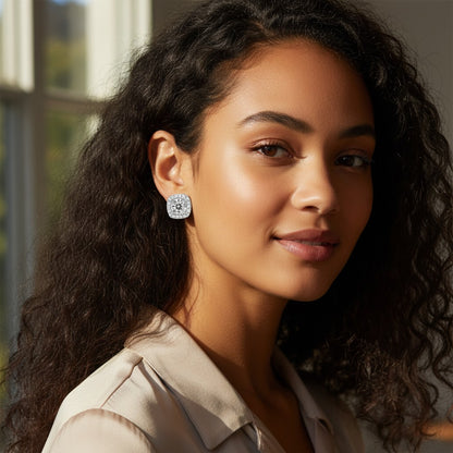 Perlizia platinum-plated sterling silver stud earrings with round moissanite center and halo of small stones.